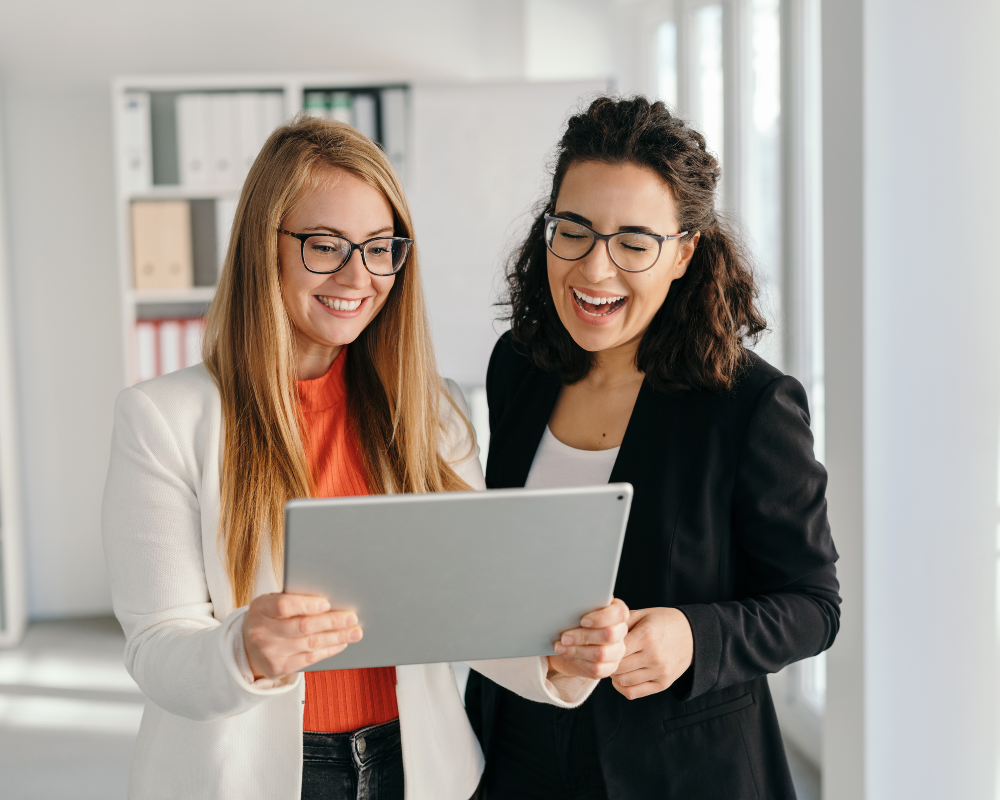 Two women looking at a tablet together